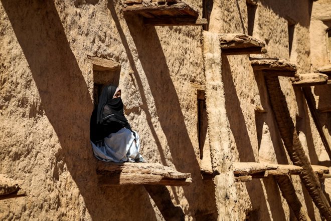 A woman sits in an old granary in the village of Aït Kine, Morocco, on March 1, 2023.