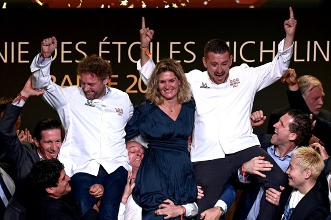 French chef Arnaud Donckele (left), French chef Dimitri Droisneau (right) and his wife Marielle Droisneau (centre) celebrate their third Michelin Guide star in Cognac, western France, March 22, 2022