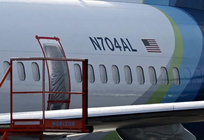 The location of the missing emergency door on Alaska Airlines' Boeing 737 MAX 9, covered with plastic sheeting at Portland Airport, January 23, 2024