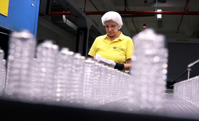 Employee Michaela Trebes inspects vials on a production line at the Heinz-Glas company on August 3, 2022 in Kleintettau, Germany