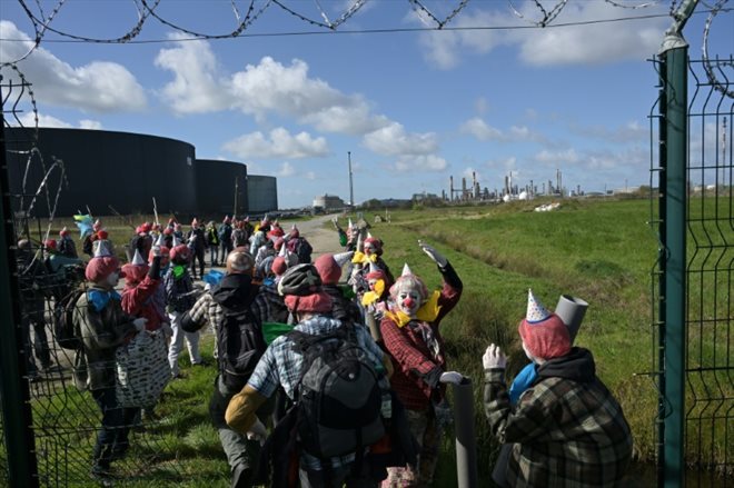 Activists from Extinction Rebellion (ER) dressed as clowns on the site of the TotalEnergies refinery in Donges (Loire-Atlantique) on March 23, 2024