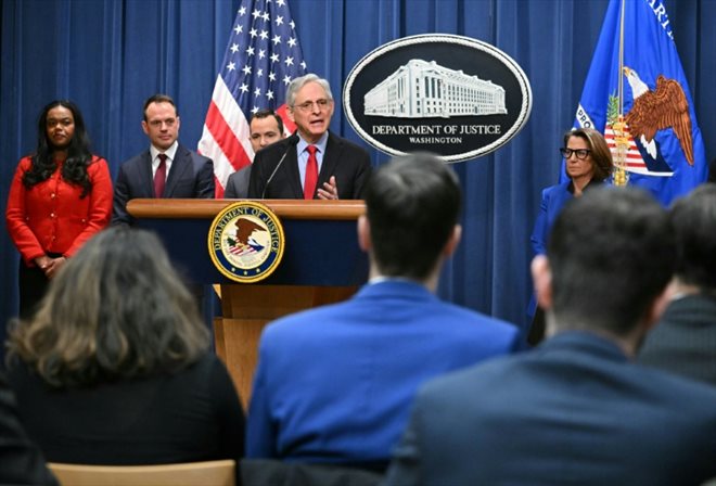 US Attorney General Merrick Garland (c) during a press conference announcing an antitrust lawsuit against Apple, March 21, 2024 in Washington