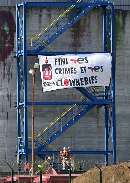 Activists from Extinction Rebellion (ER) dressed as clowns on the site of the TotalEnergies refinery in Donges (Loire-Atlantique) on March 23, 2024