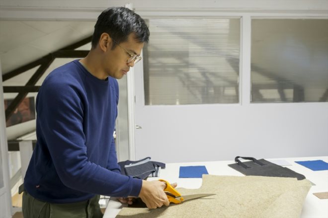 Davy Dao, créateur de la marque Dao, découpe une matière à base de lin dans les locaux de son entreprise à Maxeville, le 23 novembre 2023 en Meurthe-et-Moselle