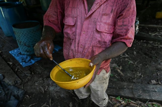 A man demonstrates the process of producing coca paste at a laboratory near the municipality of Olaya Herrera, Colombia, May 12, 2023